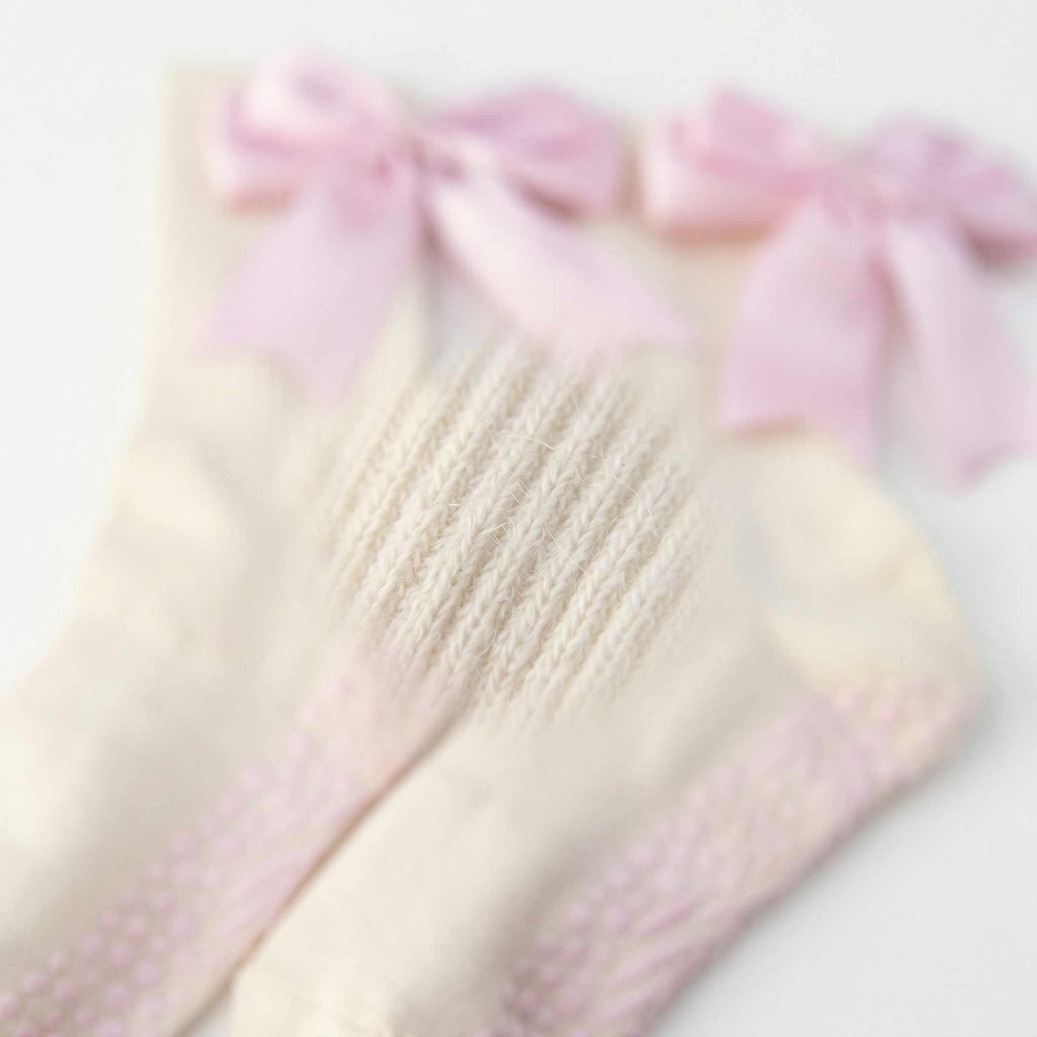 Light pink organic cotton Pilates grip socks by Bellona Velvet featuring a minimalist ankle bow and a durable non-slip dual-grip sole for reformer workouts.