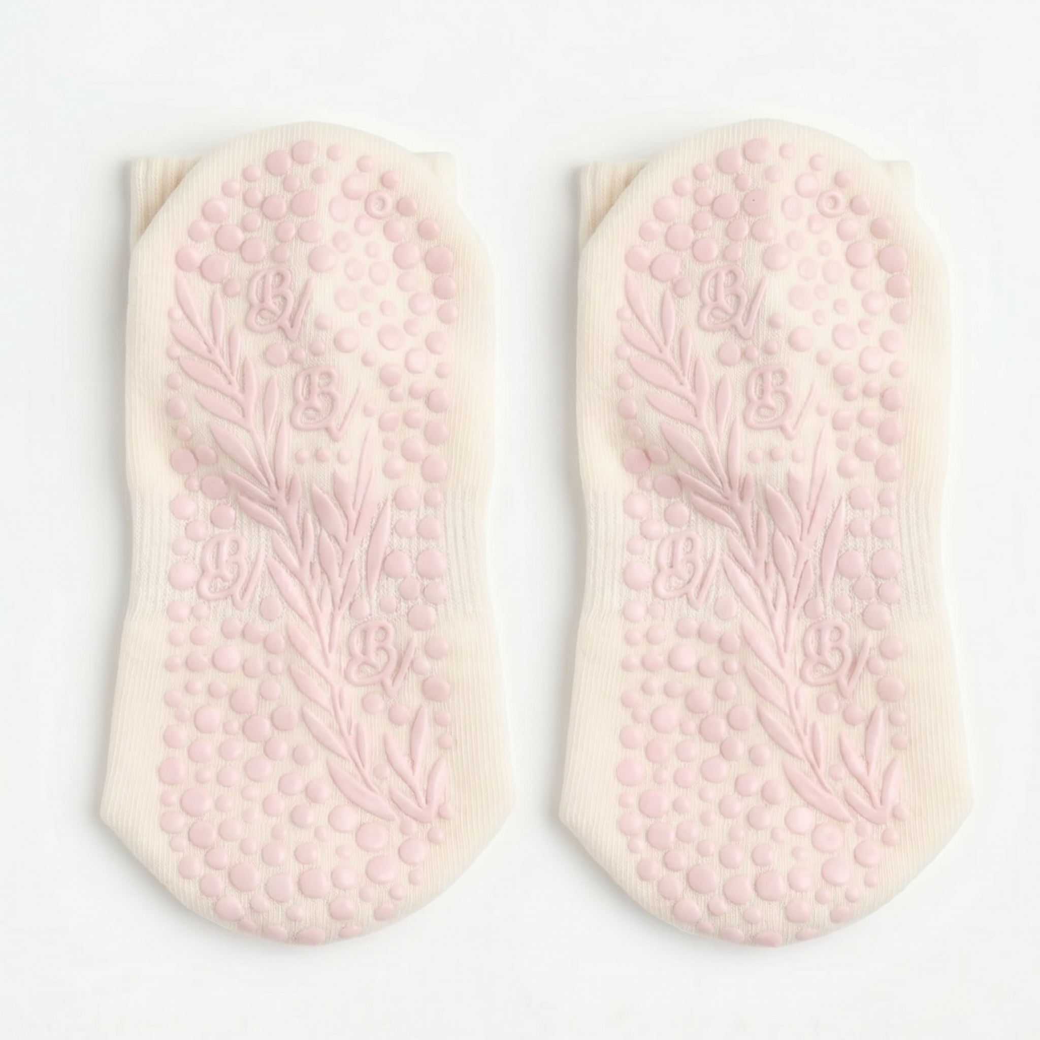 The Minimalist Grip Crew – Organic Cotton - Pink socks feature a light pink sole with floral and dotted textures and a B logo, designed for comfort and stability, shown on a white background.