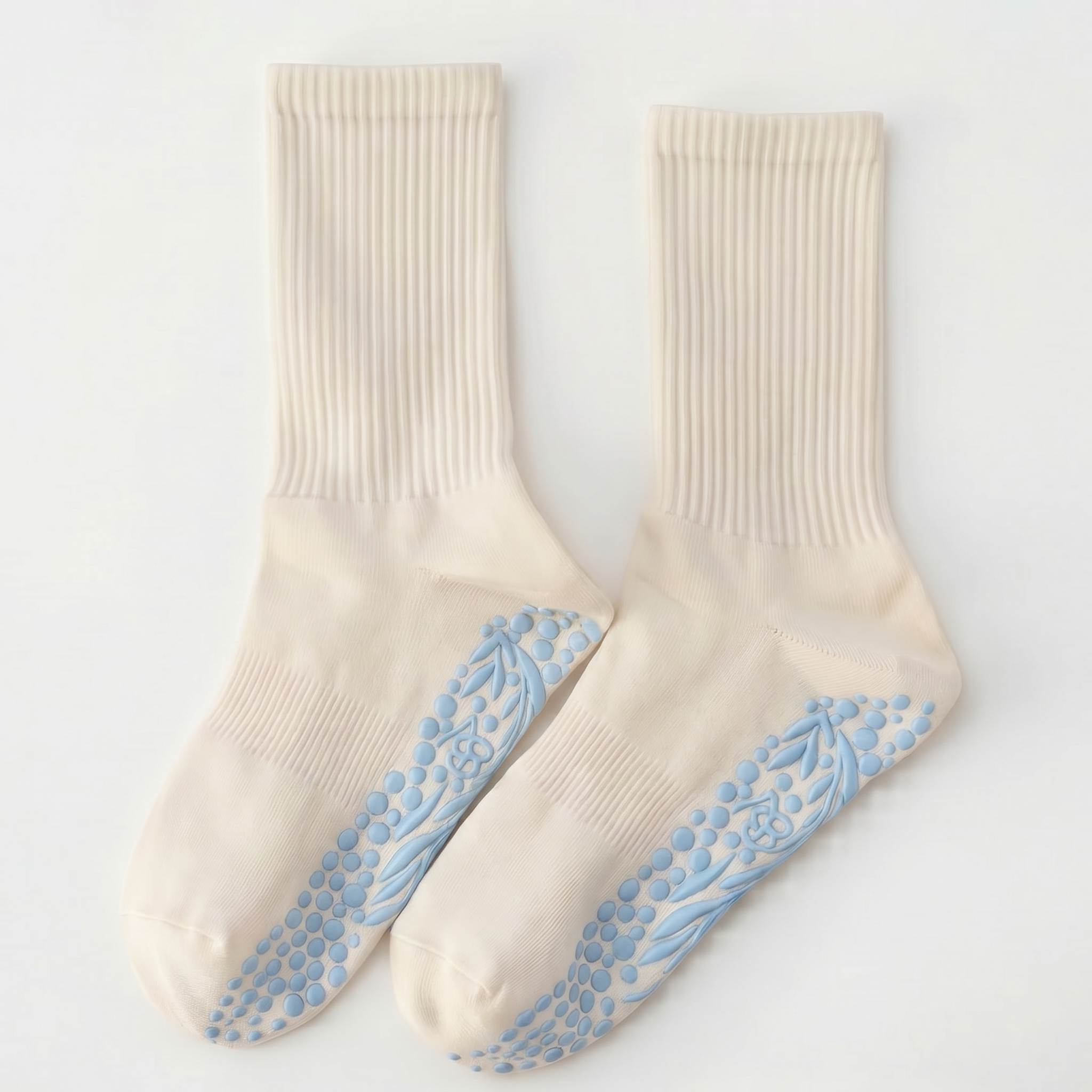 The Minimalist Grip Crew – Organic Cotton - Baby Blue socks feature cream-colored ribbed fabric and blue non-slip grip patterns, shown laid flat on a white background.